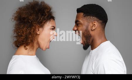 Young couple yelling at each other in studio Stock Photo