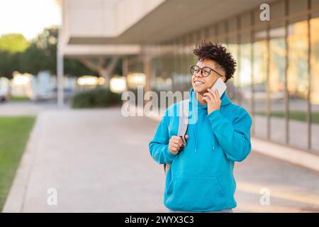 Young man walking and talking on the phone Stock Photo