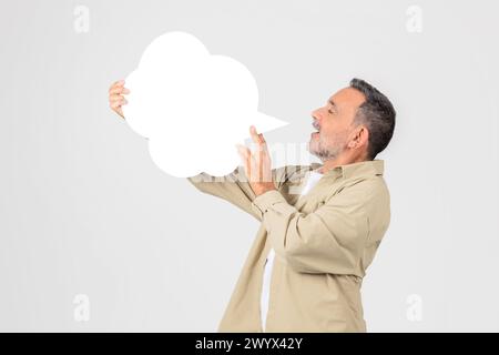 Man holding a blank white speech bubble Stock Photo