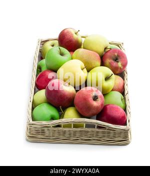 Green  yellow and red apples in wicker basket isolated on white Stock Photo