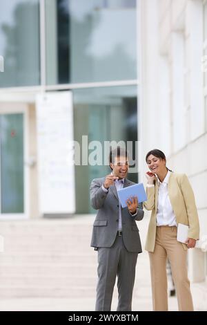 Businessman and business woman with tablet in business center. San Sebastian Technology Park. Donostia. Gipuzkoa. Basque Country. Spain. Stock Photo