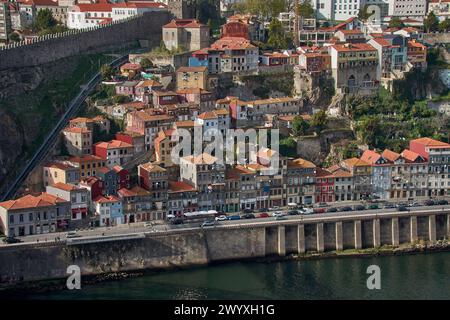 Porto,Portugal; March, 28,2022;Douro river and local houses with orange roofs in Porto city aerial panoramic view. Porto is the second largest city in Stock Photo