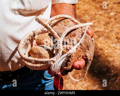 Close up. Shepherds sling demonstration. A sling is a projectile weapon ...