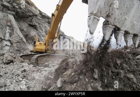 Extracting raw material from quarry for cement manufacturing. Stock Photo