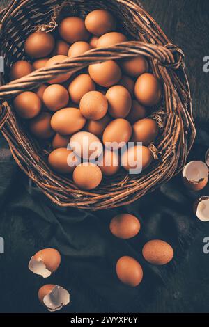 Fresh organic eggs from farm in a basket placed on wooden table Stock Photo