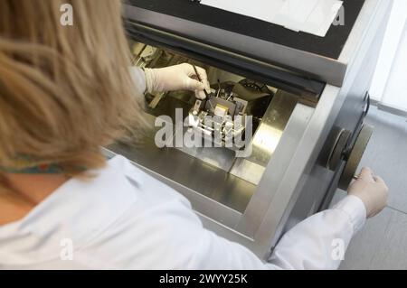 Staff working with the cryotome, special equipment for cutting tissues. Laboratory, Fundación Inbiomed, Genetrix Group. Center for research in stem cells and regenerative medicine. Donostia, San Sebastian, Euskadi. Spain. Stock Photo
