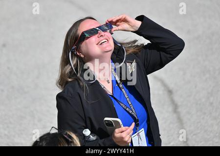 Indianapolis, United States. 08th Apr, 2024. A spectator uses solar glasses to view the solar eclipse at the Indianapolis Motor Speedway on April 8, 2024 in Indianapolis, Indiana. Situated in the “path of totality”, over 50,000 spectators are expected at the famed racing venue to experience a total solar eclipse which occurs when the moon passes in between the sun and the Earth, appearing to block the sun. (Photo by Sam Wasson/Sipa USA) Credit: Sipa USA/Alamy Live News Stock Photo