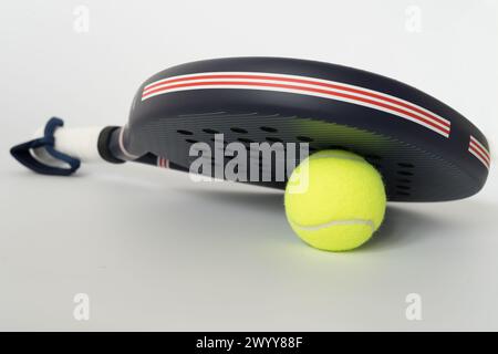 blue professional paddle tennis racket with yellow ball on white background. copy space for text Stock Photo