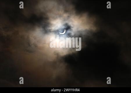 The moon is seen partially covering the sun during a total solar eclipse, in Toronto, Monday, April 8, 2024. Credit: The Canadian Press/Ģ����ý Live News Stock Photo