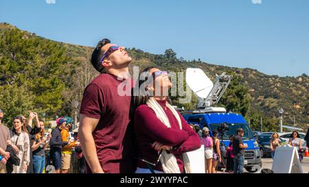 A man and a woman watching the 2024 solar eclipse in Griffith Park, Los Angeles, California, United States, on April 8, 2024. Stock Photo