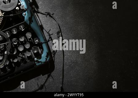 Vintage typewriter with barbed wire on black background. Printing ban concept Stock Photo