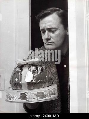 March 22, 1966, London, England, United Kingdom: Actor ROBERT VAUGHN who plays the part of Napoleon Solo, as the Man From U.N.C.L.E. series receiving an Easter egg at his London hotel yesterday. And behaving in keeping with his new role, as if the gift from a fan is a bomb to blow him up. (Credit Image: © Keystone Press Agency/ZUMA Press Wire). EDITORIAL USAGE ONLY! Not for Commercial USAGE! Stock Photo