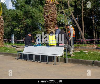 Batumi, Georgia. 03.27.2024   Workers on a smoke break. Worker's rest. Repair work in the park. road repair work. Stock Photo
