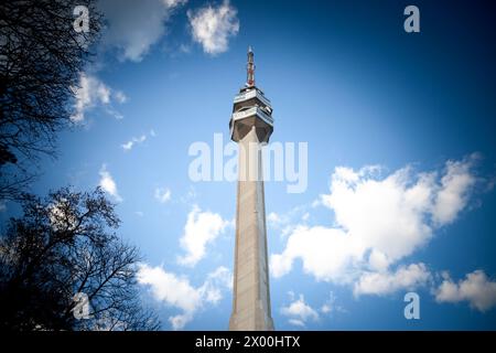 Picture of the Avala tower, or Avala toranj, seen from a nearby forest. It is a TV tower and broadcasting antenna in the suburbs of Belgrade, Serbia. Stock Photo