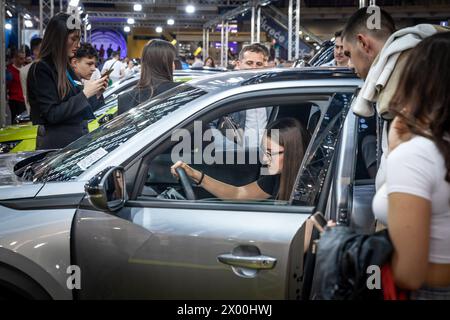 Picture of people trying a car, mainly a young woman, in a car dealership in belgrade, serbia. Stock Photo