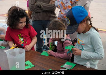 Attendees create devices to see a projection of the partial solar eclipse outside of the Cradle of Aviation Museum's Solar Eclipse Viewing Party and Activities event in Garden City, Nassau County, Long Island, New York. A solar eclipse moved across North America, completely blocking the sun in its path over certain areas of Mexico, the United States and Canada. Most American locations, including Long Island and New York City, witnessed a partial eclipse. The eclipse was caused by the moon orbiting in between the sun and the Earth, temporarily blocking the sun. The next total solar eclipse over Stock Photo