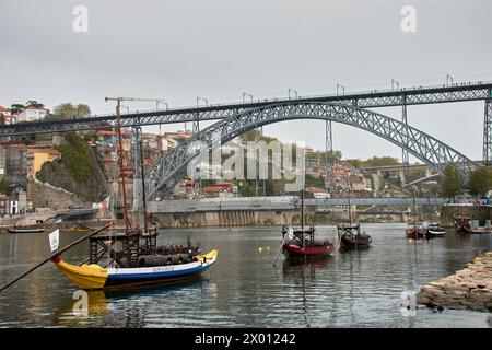 Porto, Portugal, March, 28,2022; Traditional Portuguese Rabelos boats for transporting wine in Ribera del Duero, Dom Luis Bridge Stock Photo