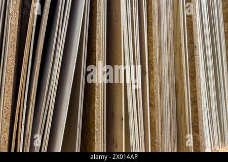 End view of plywood sheets of various thicknesses standing vertically. Close up. Stock Photo