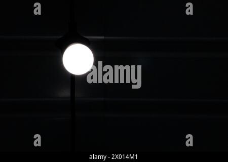 lamp burning in the dark. Energy saving. Blackout Stock Photo