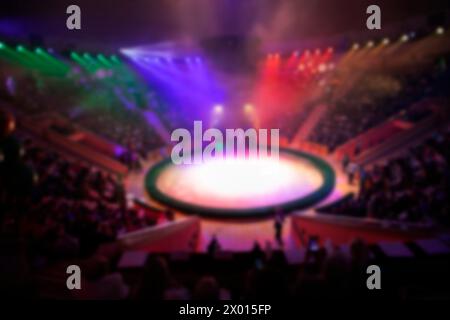 Blurred circus arena in light rays and multi-colored lights. Stock Photo