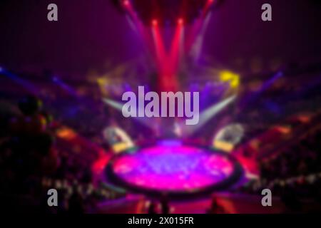 Blurred circus arena in light rays and multi-colored lights. Stock Photo