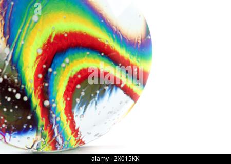 Optical abstract background of rainbow fabric with kinks and light effects in water drops. Stock Photo