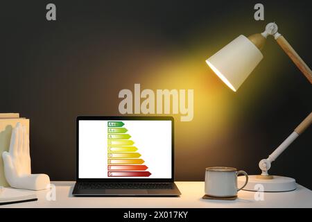 Energy efficiency rating on laptop display. Workplace with modern computer Stock Photo