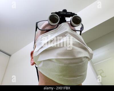 Dentist with magnifying glasses on Feb 28 2024 in Marktoberdorf, Germany. Credit: ddp images / star-images Stock Photo