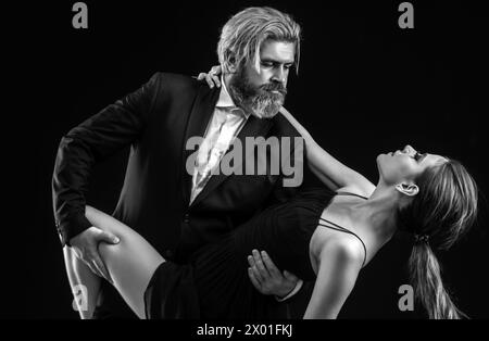 Salsa dancing couple. Young luxury pair dance isolated on black background. Romantic. Stock Photo