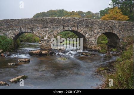 The 18th century road bridge over the East Dart River in the Dartmoor National Park at Postbridge, Dartmoor, Devon, England UK Stock Photo