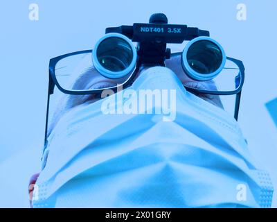 Dentist with magnifying glasses on Feb 28 2024 in Marktoberdorf, Germany. Stock Photo