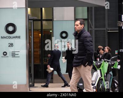 Pedestrians walking past Macquarie Bank Ropemaker Street, London Stock Photo