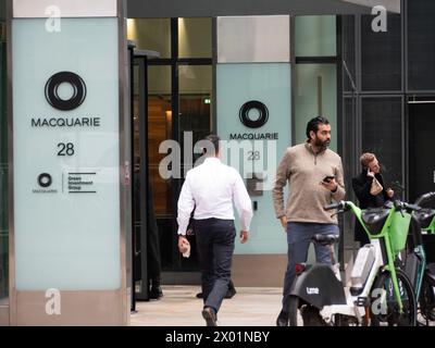 Pedestrians walking past Macquarie Bank Ropemaker Street, London Stock Photo