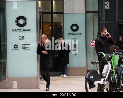 Pedestrians walking past Macquarie Bank Ropemaker Street, London Stock Photo