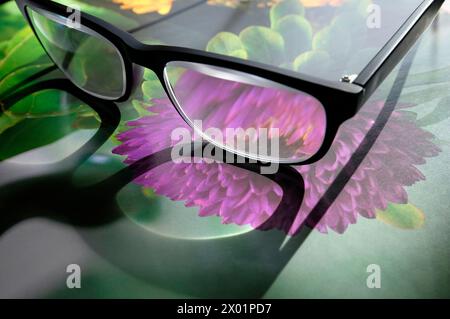 reading glasses on gardening book Stock Photo