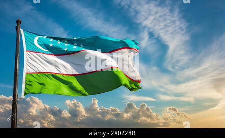 Fahnen, die Nationalfahne von Usbekistan flattert im Wind Stock Photo