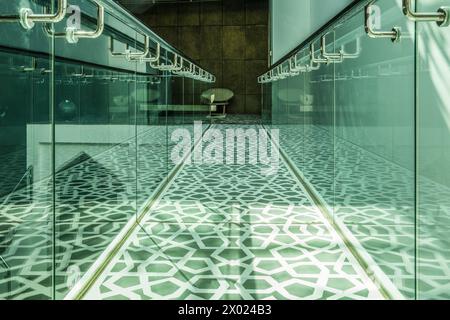 MUHARRAQ, BAHRAIN - FEBRUARY 10, 2018:  Light shines onto a balcony walkway decorated with islamic geometrical patterns in a museum in the middle east Stock Photo