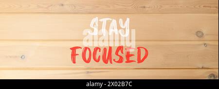 Stay focused symbol. Concept words Stay focused on beautiful wooden wall. Beautiful wooden wall background. Business, support, motivation, psychologic Stock Photo