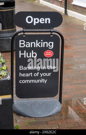 Rain in Sidmouth outside the new Banking Hub, operated by the Post Office. All the remaining banks have now closed. Banking hub sign. Stock Photo
