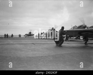 ACTIVITY ON BOARD HMS VICTORIOUS. FEBRUARY 1942, ON BOARD THE AIRCRAFT CARRIER AT SEA IN THE NORTH ATLANTIC AND OFF THE NORWEGIAN COAST. DURING AN OFFENSIVE AGAINST ENEMY SHIPPING AND WHILE COVERING A CONVOY TO RUSSIA. - A flight deck duty party on HMS VICTORIOUS getting Fairey Fulmar aircraft ready for flight Stock Photo