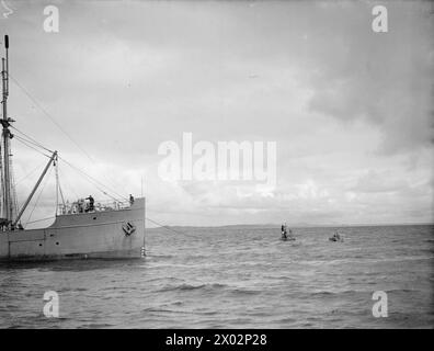 In July 1943, HMT Stella Pegasi escorts the Northern Lights vessel Pole Star to deliver stores and supplies to lighthouse crews along the coast, refueling a war channel buoy. Stock Photo