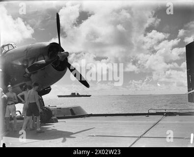 THEY BATTERED SURABAYA. 5 TO 27 MAY 1944, ON BOARD THE AIRCRAFT CARRIER HMS ILLUSTRIOUS IN THE INDIAN OCEAN. SCENES ON BOARD THE ILLUSTRIOUS WHEN AN AIRSTRIKE BY BRITISH, AMERICAN, AUSTRALIAN, FRENCH, AND DUTCH UNITS, WAS CARRIED OUT AGAINST THE JAPANESE-HELD NAVAL BASE. - USS SARATOGA with units of the Eastern Fleet on their way to Surabaya. Aircraft in picture is an Avenger Stock Photo