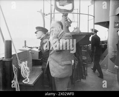 Between 12 and 21 December, Winston Churchill traveled to America aboard HMS Duke of York, during which Lord Beaverbrook participated in an anti-aircraft gun practice. Stock Photo