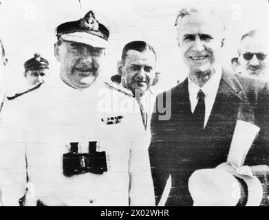 REAR ADMIRAL SIR HENRY HARWOOD RECEIVED IN MONTEVIDEO. 3 JANUARY 1940, MONTEVIDEO, URUGUAY. ADMIRAL HARWOOD ARRIVED IN THE CRUISER HMS AJAX AFTER THE BATTLE OF THE RIVER PLATE AND THE SCUTTLING OF THE GERMAN BATTLESHIP ADMIRAL GRAF SPEE. (RADIO PHOTOGRAPH?) - Rear Admiral Sir Henry Harwood with the British Minister to Uruguay, Mr E Millington-Drake after his arrival at Montevideo. Lieut E G D Lewkin in left background Stock Photo