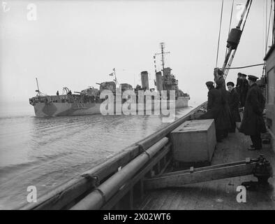 FIRST US WARSHIPS ESCORTING A CONVOY ARRIVE AT LONDONDERRY. 29 JANUARY TO 2 FEBRUARY 1942, AT LONDONDERRY, ULSTER, AMERICA'S PREMIER NAVAL BASE IN EUROPE. - An American destroyer being watched by British sailors from a passing ship as it steams into port Stock Photo