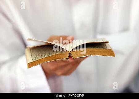 Muslim man reading an Arabic Holy Quran (Koran), Jamiul Azhar Mosque, Vietnam, Indochina, Southeast Asia, Asia Stock Photo