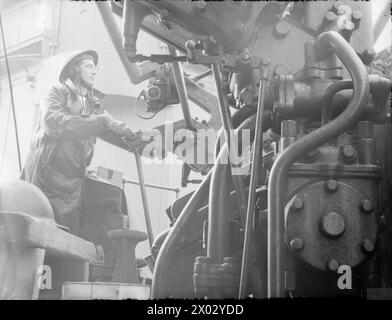 In September 1940, officers and crew are shown on board the battleship HMS Rodney, with a member of the crew operating a multiple pom-pom anti-aircraft gun. Stock Photo
