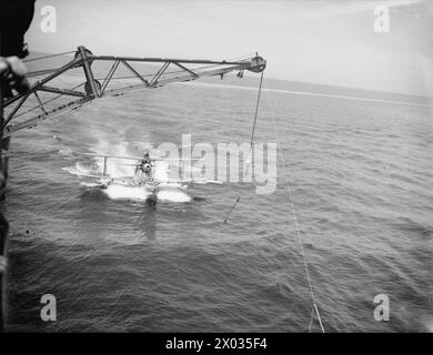 Crew aboard HMS Sheffield hoist in paravanes while escorting a British ...