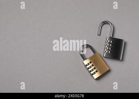 Steel combination padlocks on grey background, top view. Space for text Stock Photo