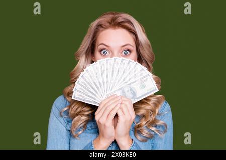 Close-up portrait of her she nice cute charming mysterious wavy-haired lady wearing blue shirt hiding behind large sum spend expense income rich Stock Photo